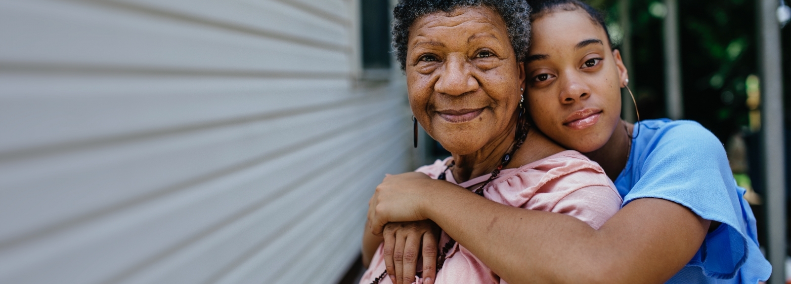 younger woman hugging older woman